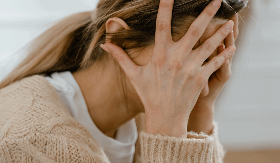 women stressed holding head