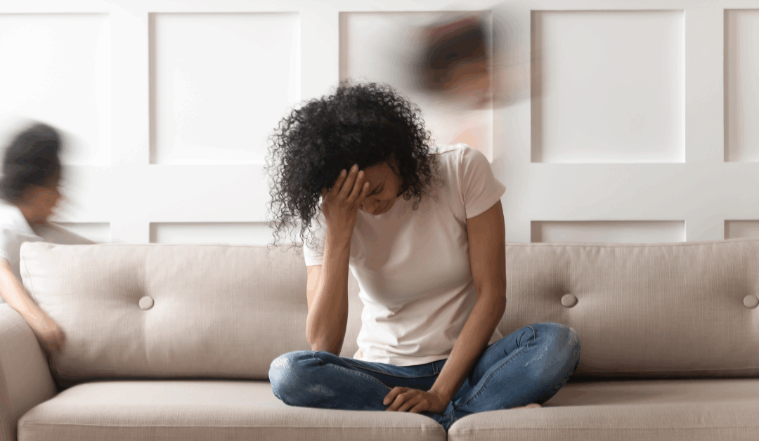 mom looking down on couch kids running around