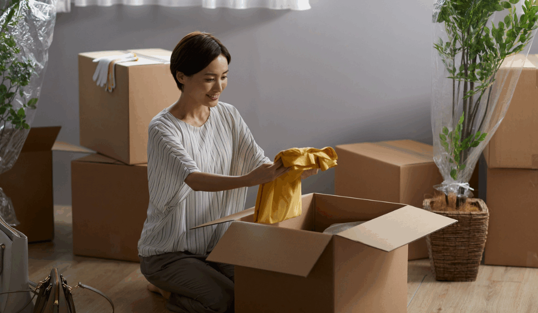 woman packing up moving boxes