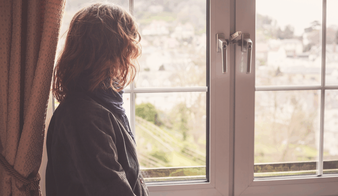 person looking out window reflecting quiet quitting